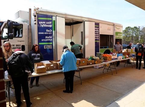 Helping hands food pantry and Fulfill food bank setting up food donations to students from the fulfill truck